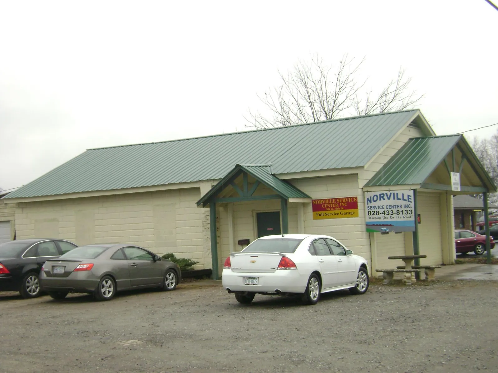 Green metal roof on a service garage with a covered entry in Craigsville